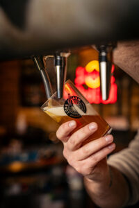 a bartender pouring a pint of beer
